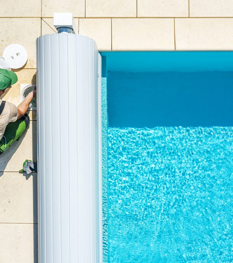 outdoor-swimming-pool-skimmer-filter-cleaning-aerial-view.jpg